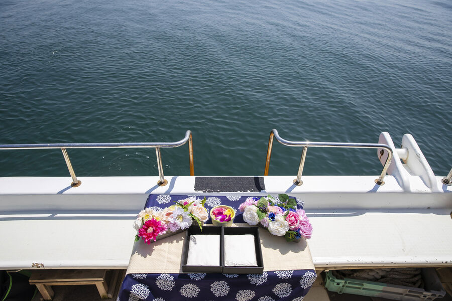 Ceremony set with flowers and sake prepared on deck